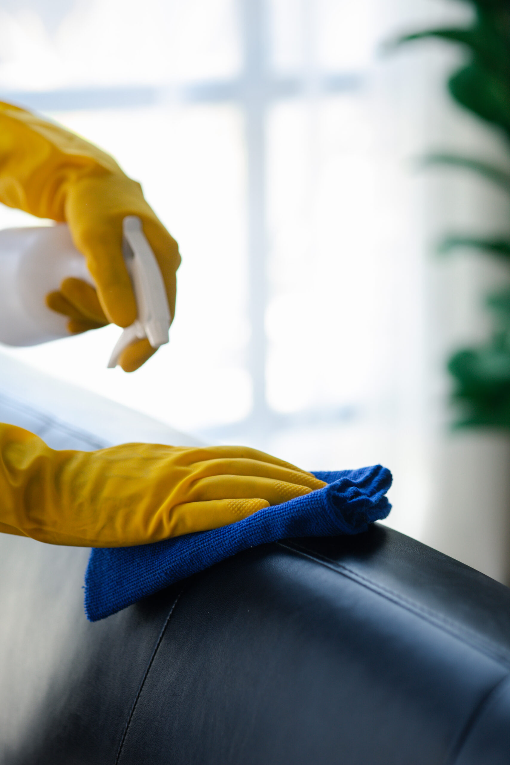 person cleaning room cleaning staff is using cloth spraying disinfectant wipe sofas company office room cleaning staff maintaining cleanliness organization 2 scaled